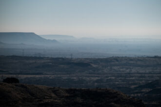 Smoke hangs in the Canadian River Valley south of Stinnett, Texas after multiple days of wild fires on March 1. Credit: Justin Rex/The Texas Tribune