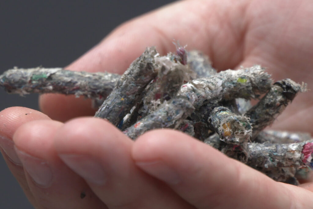 Pellets made from plastic waste by Cyclyx International in a laboratory setting. Credit: Dwaine Scott/CBS News