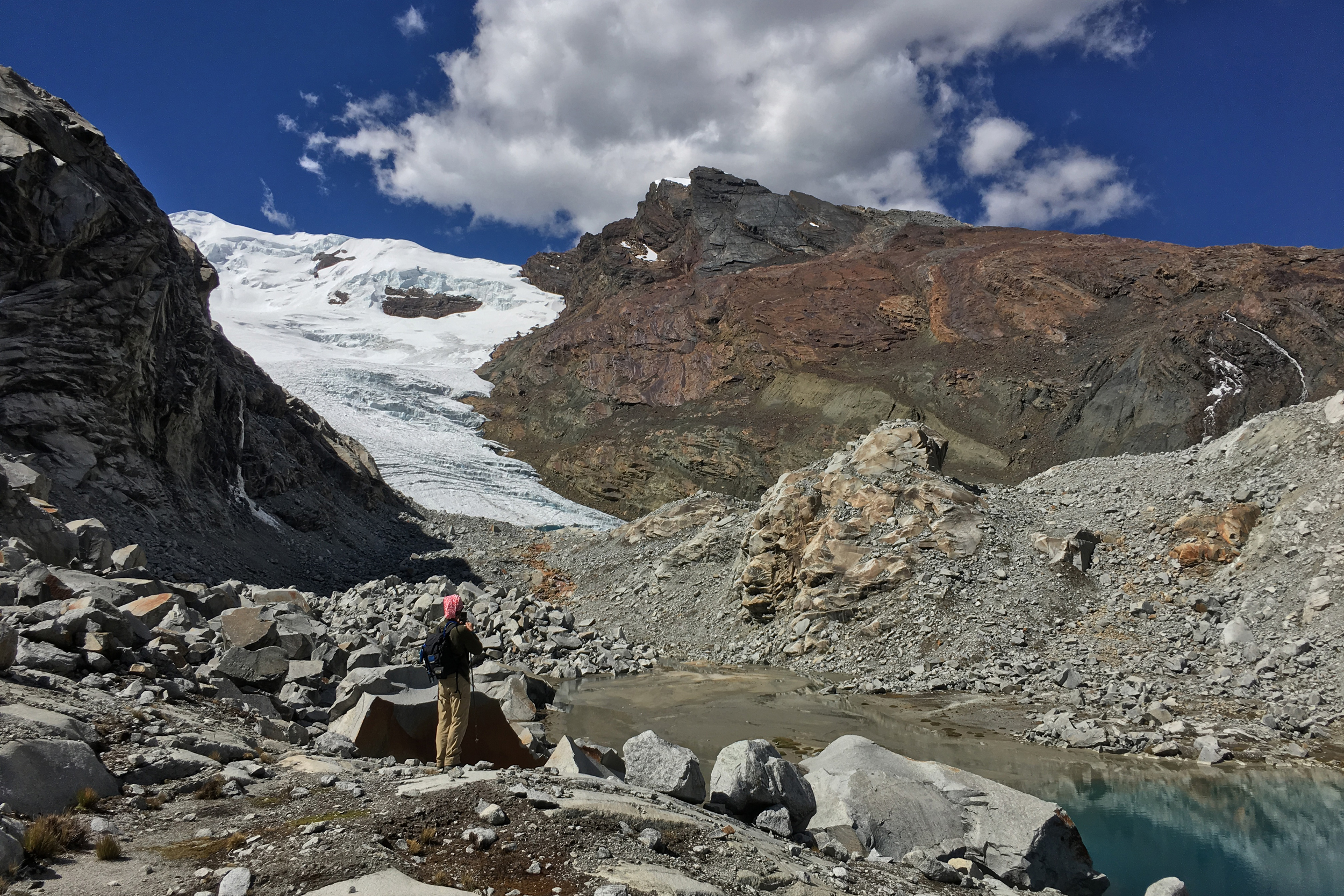 Research assistant, Evan Vega, takes in the view of Queshque Glacier and the glacially carved landscape around him. Credit: Emilio Mateo