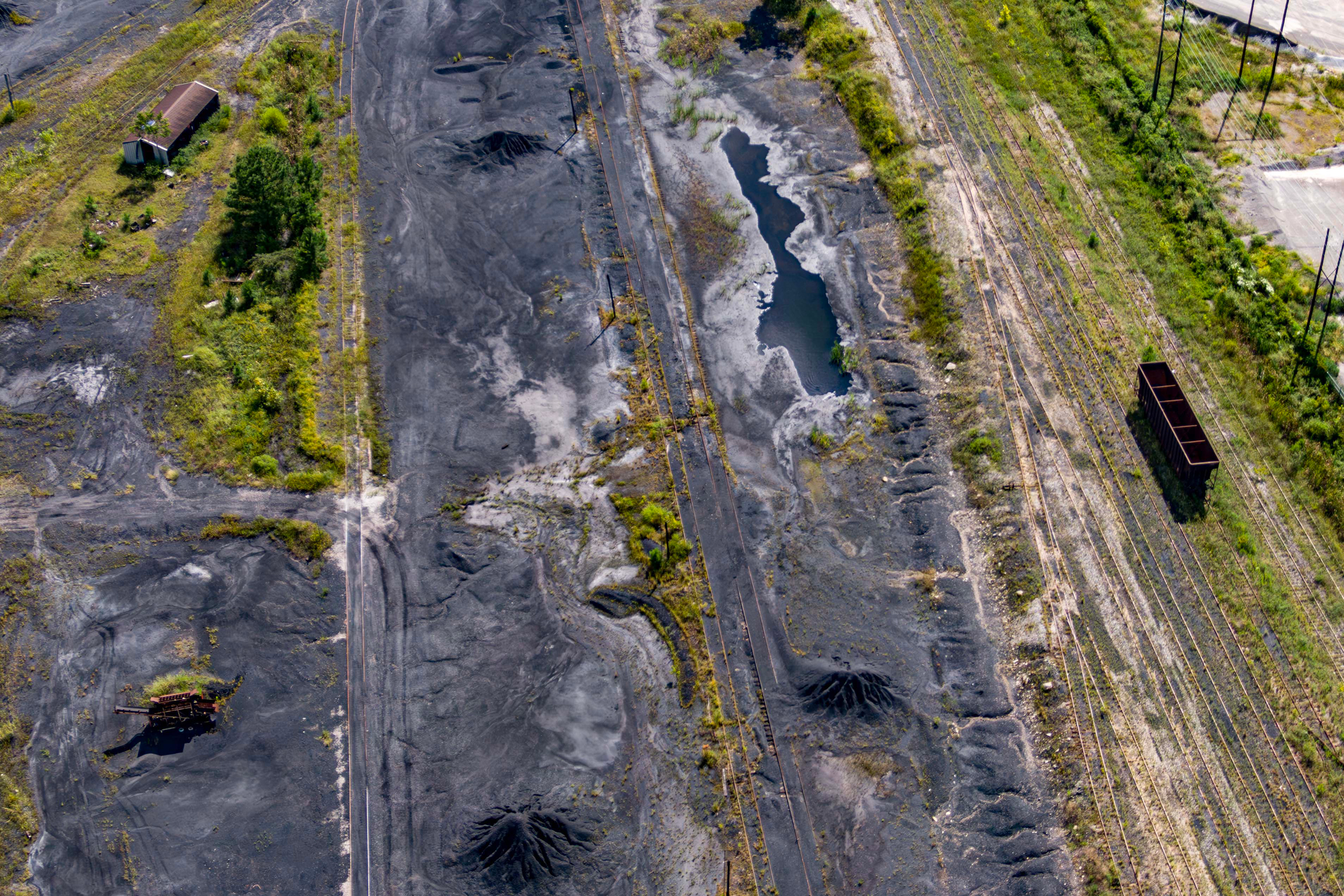 Environmental groups say runoff from piles of coal and coke waste continues to pollute groundwater and nearby Five Mile Creek at the shuttered Bluestone Coke facility in Birmingham, Ala. Credit: Lee Hedgepeth/Inside Climate News