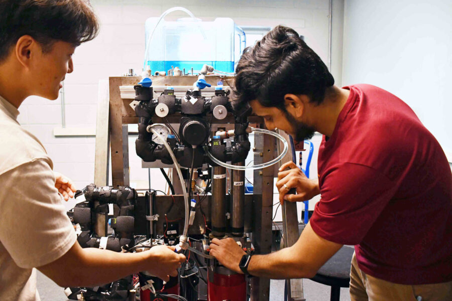 University of Maryland graduate research assistants work on an elastocaloric cooling system prototype at the the school’s Center for Environmental Energy Engineering. Credit: Courtesy of Beth Panitz