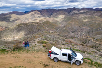 Melissa (left) and Steve Fry look out at the proposed mine site in the Galiuro Mountains outside Mammoth, Arizona, on March 14. Credit: Michael McKisson/Arizona Luminaria