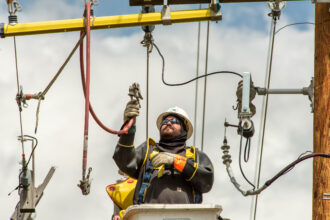 Linemen work on a rebuild of Northwestern Energy transmissions lines in Livingston, Montana. Credit: William Campbell/Getty Images