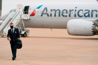 A pilot walks away from an American Airlines plane at Dallas Fort Worth International Airport in Texas. Credit: Cooper Neill/AFP via Getty Images