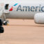 A pilot walks away from an American Airlines plane at Dallas Fort Worth International Airport in Texas. Credit: Cooper Neill/AFP via Getty Images