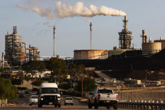 Vehicles pass the Phillips 66 Los Angeles Oil Refinery in Wilmington, California. Credit: Mario Tama/Getty Images