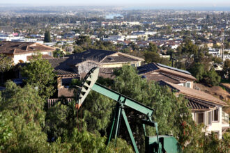 An oil pumpjack sits near homes in Signal Hill, Calif. Credit: Mario Tama/Getty Images