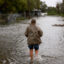 A person walks through a flooded street caused by the rain and storm surge from Tropical Storm Debby on Monday in Cedar Key, Florida. Credit: Joe Raedle/Getty Images