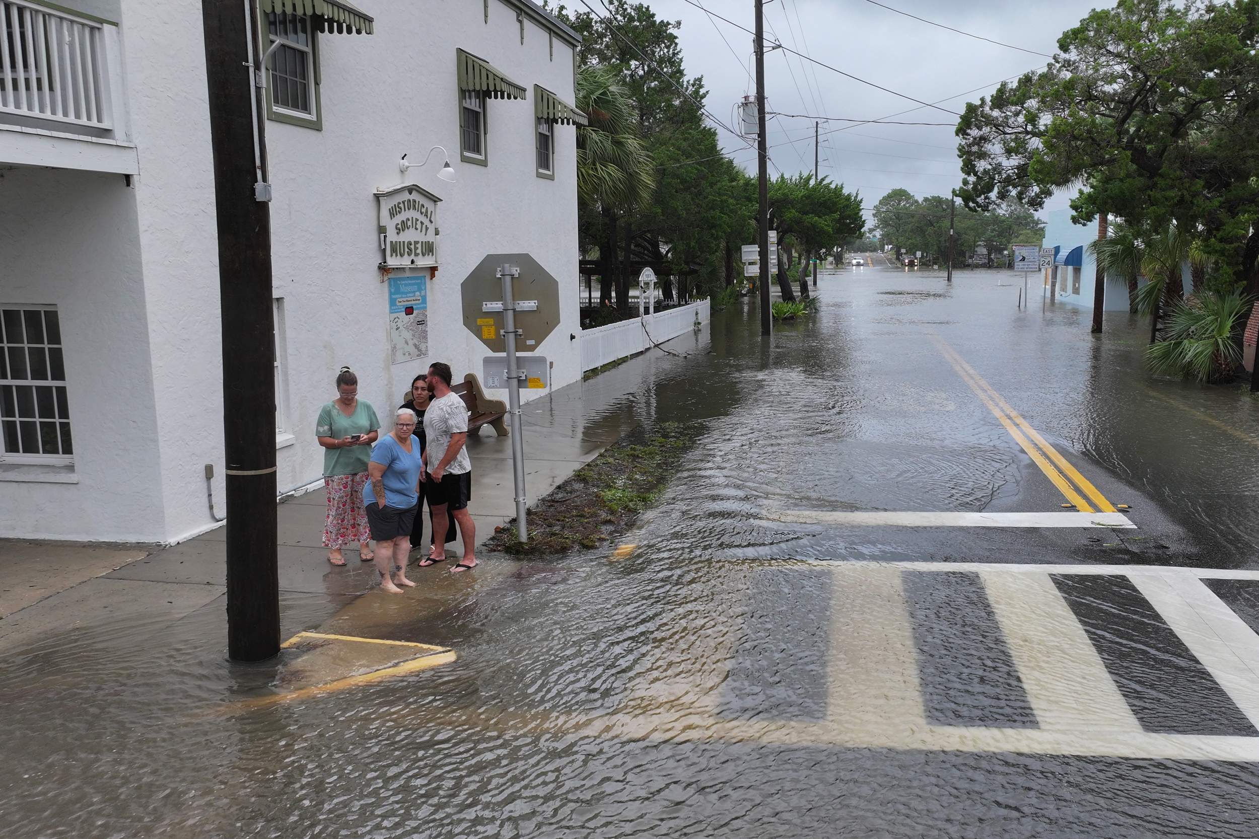 People look out onto a flooded street as Tropical Storm Debby brings rain storms and high winds along North Florida’s Big Bend area. Credit: Joe Raedle/Getty Images