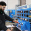 Muhammud Abu-Kass demonstrates how to work the training equipment at Guilford Tech Community College. The equipment trains him to be ready to work at Toyota’s first and only battery manufacturing plant in the U.S. Credit: Nicole Norman/Medill News Service