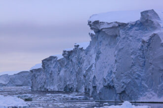 Thwaites Glacier ice cliffs can be several hundred feet high, with an area of ice nearly the size of Nebraska behind. Credit James Kirkham