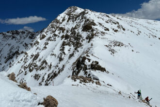 Skiers hike along the ridgeline of the East Wall at Arapahoe Basin ski area in Colorado on May 4. Credit: Michael Kodas