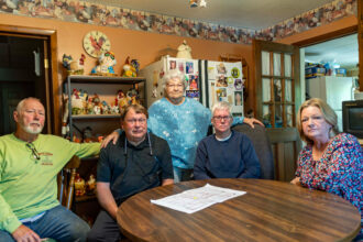 Clara Riley stands among her relatives and neighbors in her Oak Grove home. Credit: Lee Hedgepeth/Inside Climate News