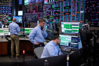 Workers monitor grid conditions in the main control room at PJM Interconnection in Valley Forge, Pa. Credit: PJM Interconnection