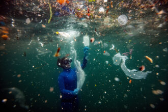 A Turkish diver dives amid plastic waste in Ortakoy coastline to observe the life and pollution of Bosphorus in Istanbul, Turkey on June 27, 2020. Credit: Sebnem Coskun/Anadolu Agency via Getty Images