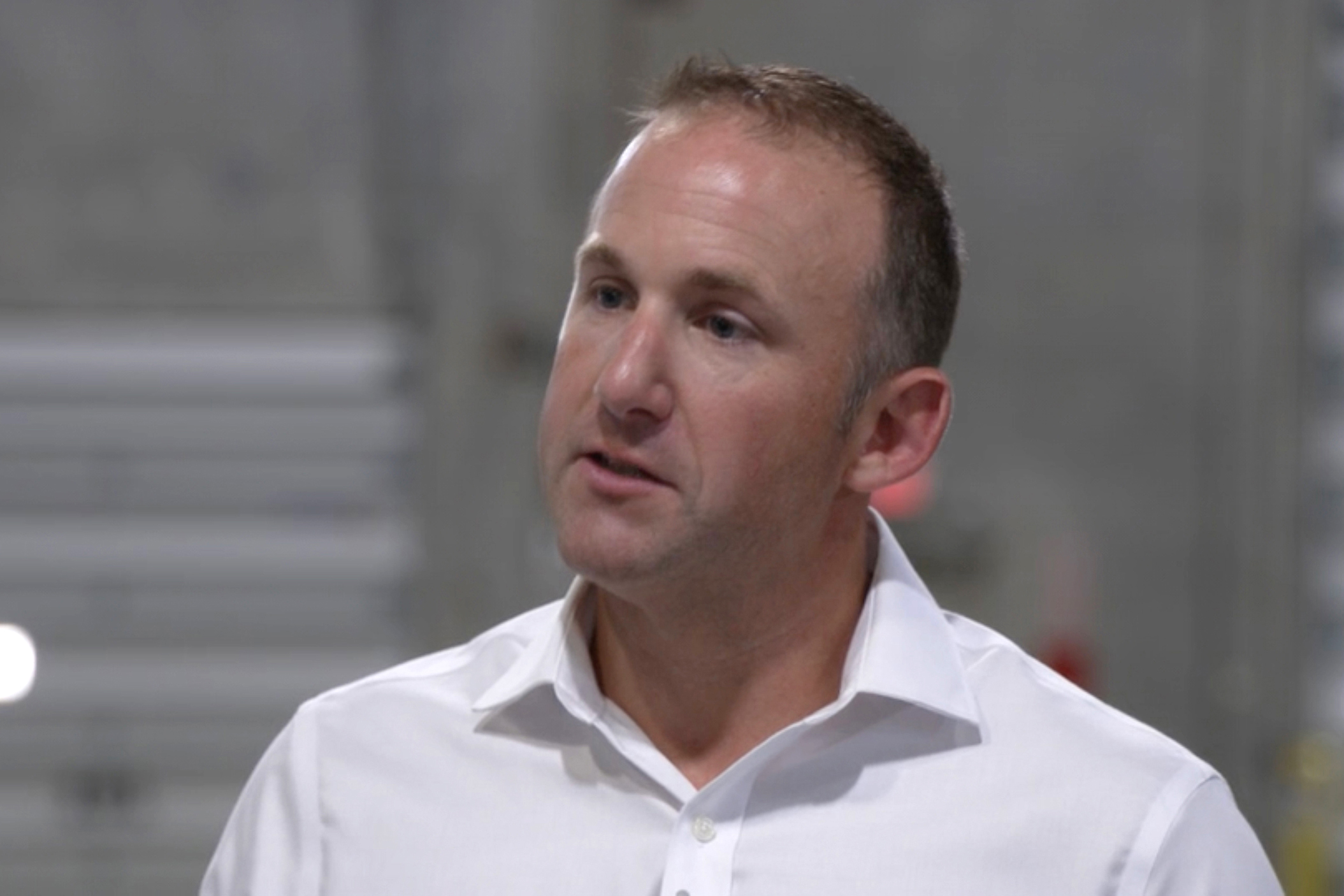 Inside a mostly empty warehouse, Cyclyx International vice president Ryan Tebbetts talks about his company's plans for a large waste plastic sorting facility in the Houston area, and its goal of getting as much as 90 percent of plastic recycled. Credit: Dwaine Scott/CBS News