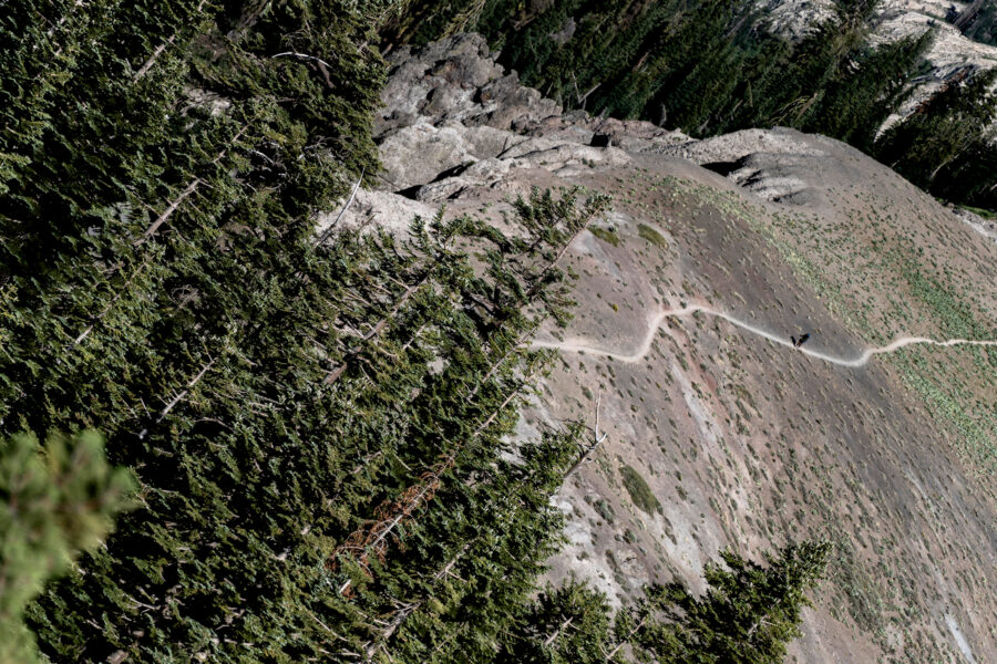 The Pacific Crest Trail footpath snakes along a mountain ridge south of Donner Summit, California, as a hiker climbs up the trail. Credit: Bing Lin/Inside Climate News