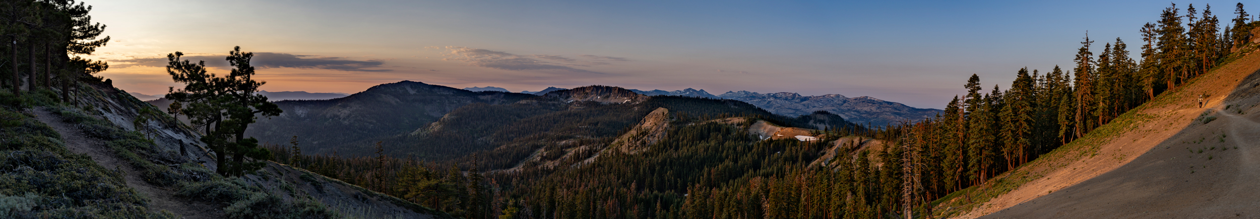 The Eldorado National Forest is seen during sunrise, while another morning hiker approaches from the right. Credit: Bing Lin/Inside Climate News 