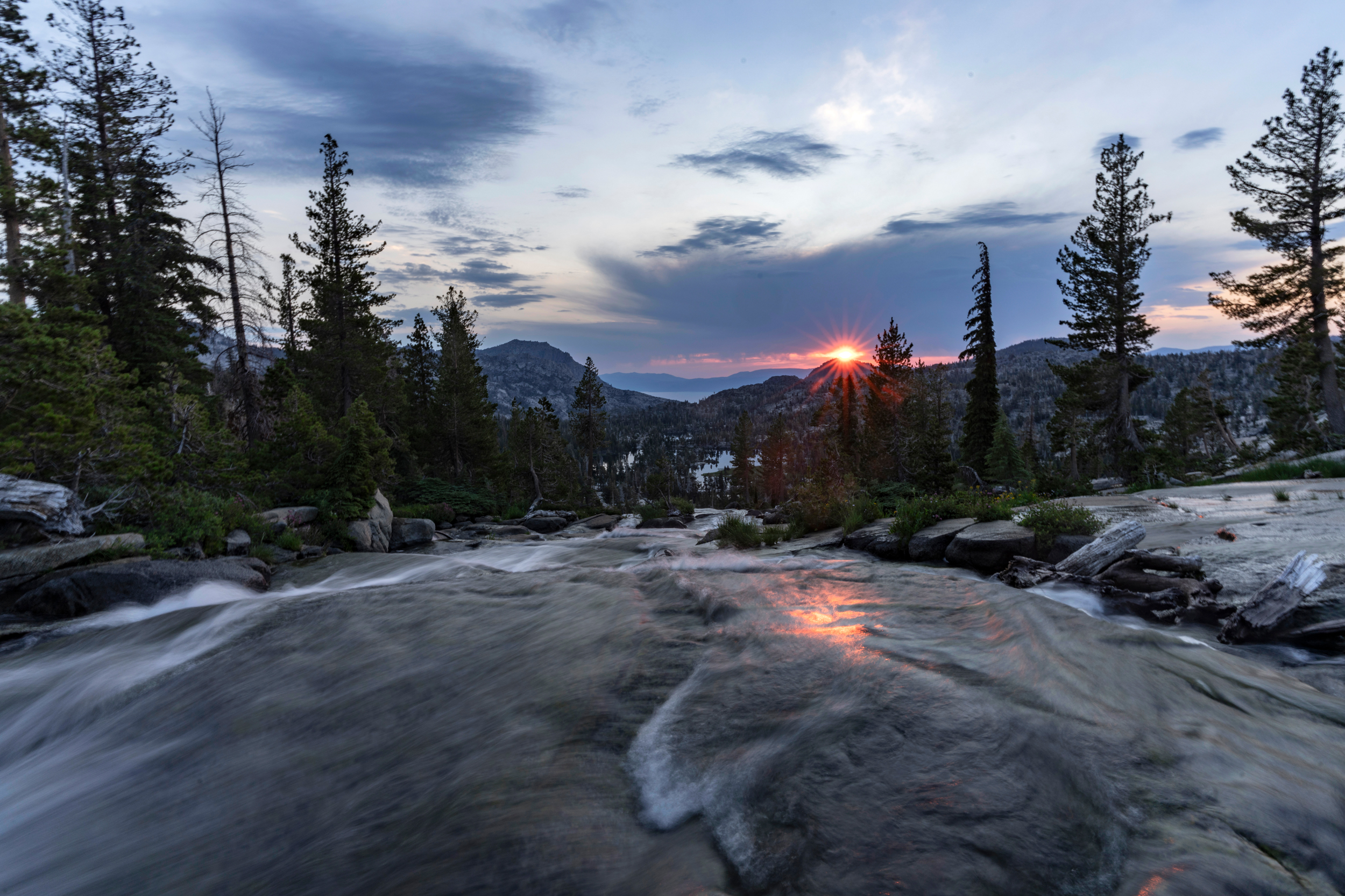 A view of the sunrise over the outlet of Fontanillis Lake in Desolation Wilderness, California. Credit: Bing Lin/Inside Climate News