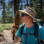 Ecologist Hugh Safford holds a sugar pine cone for size comparison on the Pacific Crest Trail near Quincy, California. Credit: Bing Lin/Inside Climate News