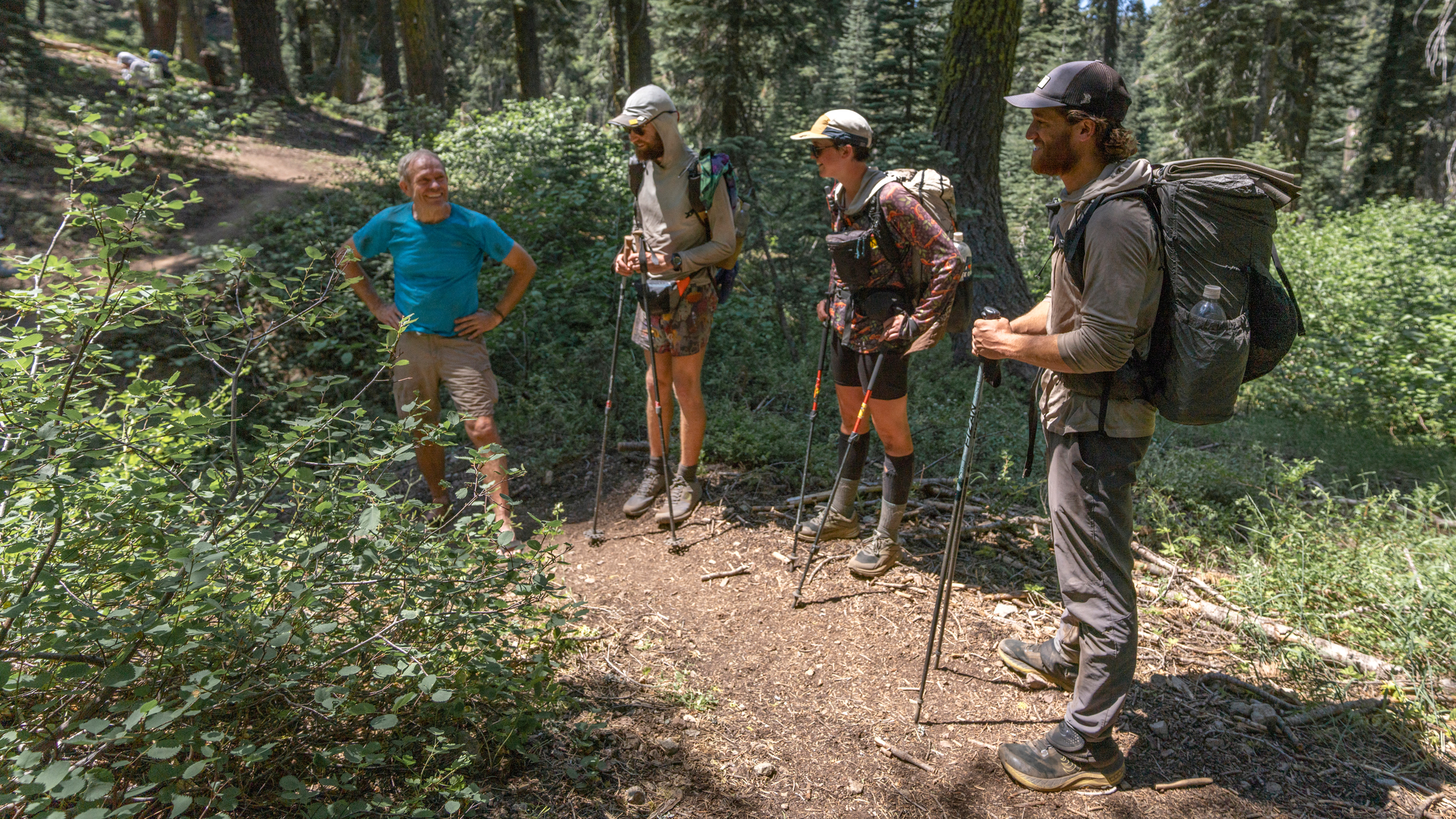 Hugh Safford conducts an impromptu botany lesson for a passing group of PCT thru-hikers. Credit: Bing Lin/Inside Climate News