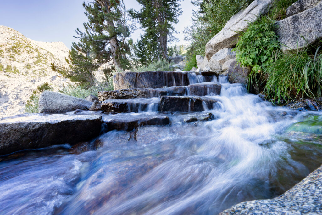 Snowmelt gushes onto the Pacific Crest Trail on the north-facing ascent of Donahue Pass. Credit: Bing Lin/Inside Climate News