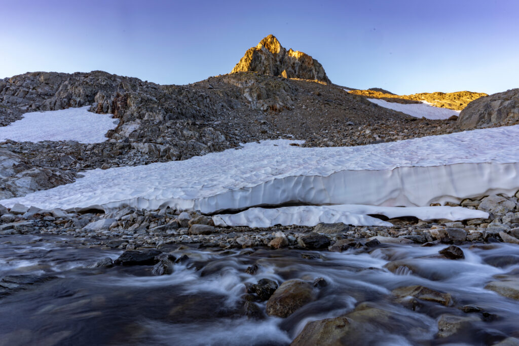 Water and ice obstruct a PCT trail on the long southbound descent down Muir Pass at sunrise. Credit: Bing Lin/Inside Climate News