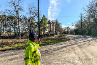 Walter Moorer observes fumes emitted from the Hosea Weaver asphalt plant near Chin Street in the historic Black community of Africatown. Credit: Patrick Darrington/Inside Climate News